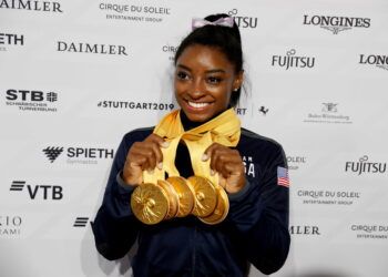 FILE PHOTO: Artistic Gymnastics - 2019 World Artistic Gymnastics Championships - Hanns-Martin-Schleyer-Halle, Stuttgart, Germany - October 13, 2019   Simone Biles of the U.S. celebrates with her five gold medals, breaking the World Championships medals record   REUTERS/Wolfgang Rattay/File Photo