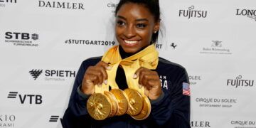 FILE PHOTO: Artistic Gymnastics - 2019 World Artistic Gymnastics Championships - Hanns-Martin-Schleyer-Halle, Stuttgart, Germany - October 13, 2019   Simone Biles of the U.S. celebrates with her five gold medals, breaking the World Championships medals record   REUTERS/Wolfgang Rattay/File Photo