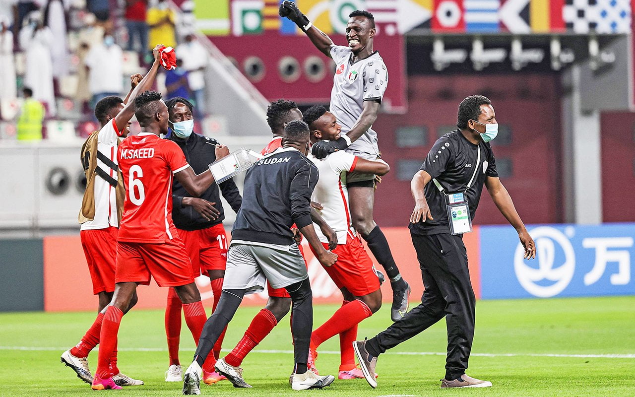 Sudan's players celebrate after winning the 2021 FIFA Arab Cup qualifying football match between Libya and Sudan at Khalifah International Stadium in Doha, Qatar, on June 19, 2021. (Photo by KARIM JAAFAR / AFP)