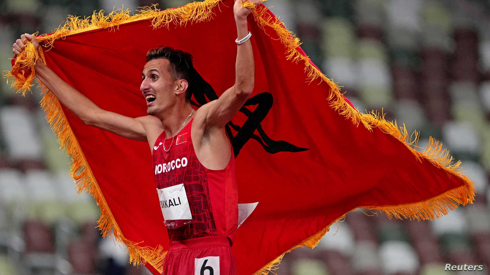 Aug 2, 2021; Tokyo, Japan; Soufiane El Bakkali (MAR) celebrates winning the gold medal in the men's 3000m steeplechase during the Tokyo 2020 Olympic Summer Games at Olympic Stadium. Mandatory Credit: Kirby Lee-USA TODAY Sports