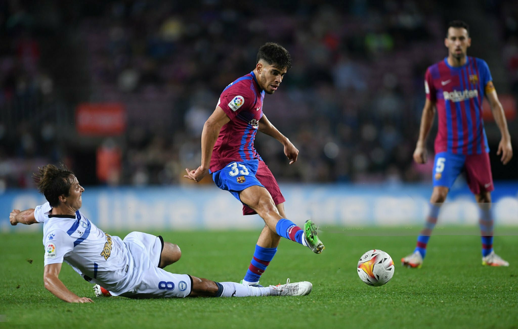 BARCELONA, SPAIN - OCTOBER 30: Abdessamad Ezzalzouli of FC Barcelona is challenged by Tomas Pina of Deportivo Alaves during the LaLiga Santander match between FC Barcelona and Deportivo Alaves at Camp Nou on October 30, 2021 in Barcelona, Spain. (Photo by Alex Caparros/Getty Images)