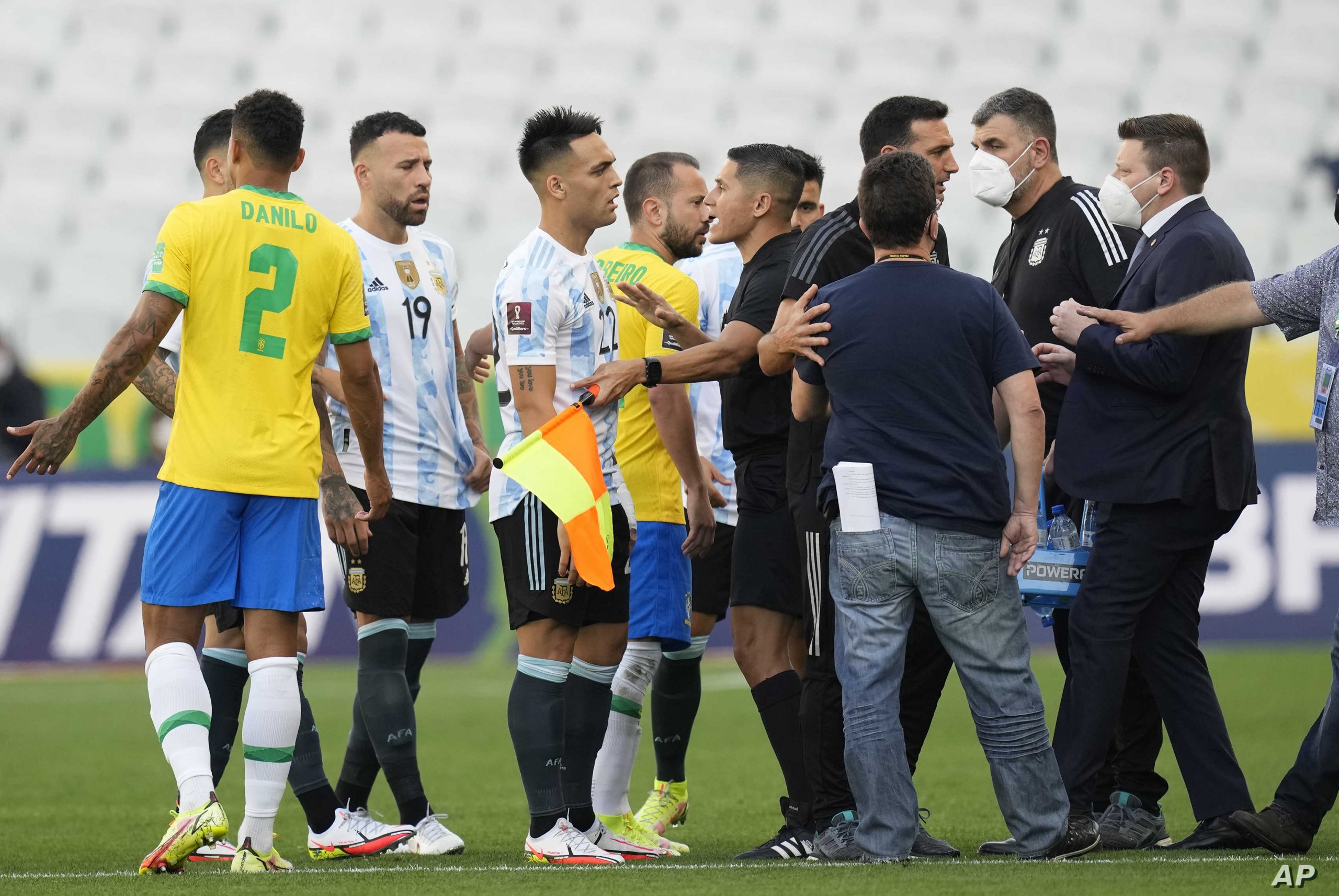 Brazil and Argentina's player talk as the soccer game is interrupted by health authorities during a qualifying soccer match for the FIFA World Cup Qatar 2022 at Neo Quimica Arena stadium in Sao Paulo, Brazil, Sunday, Sept.5, 2021. (AP Photo/Andre Penner)