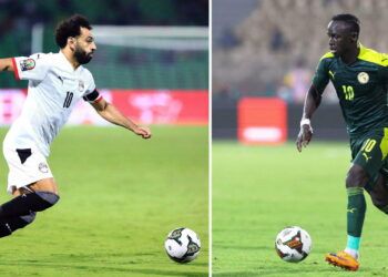 (COMBO) This combination of file pictures made on February 4, 2022, shows, at left, Egypt's forward Mohamed Salah in Garoua on January 15, 2022; and Senegal's forward Sadio Mane in Yaounde on February 2, 2022. - Senegal will face Egypt in the Africa Cup of Nations (CAN) 2021 final football match, scheduled for February 6, 2022, at Stade d'Olembe in Yaounde. (Photo by Daniel BELOUMOU OLOMO and Kenzo TRIBOUILLARD / AFP) (Photo by DANIEL BELOUMOU OLOMO,KENZO TRIBOUILLARD/AFP via Getty Images)