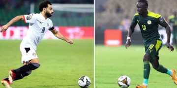 (COMBO) This combination of file pictures made on February 4, 2022, shows, at left, Egypt's forward Mohamed Salah in Garoua on January 15, 2022; and Senegal's forward Sadio Mane in Yaounde on February 2, 2022. - Senegal will face Egypt in the Africa Cup of Nations (CAN) 2021 final football match, scheduled for February 6, 2022, at Stade d'Olembe in Yaounde. (Photo by Daniel BELOUMOU OLOMO and Kenzo TRIBOUILLARD / AFP) (Photo by DANIEL BELOUMOU OLOMO,KENZO TRIBOUILLARD/AFP via Getty Images)