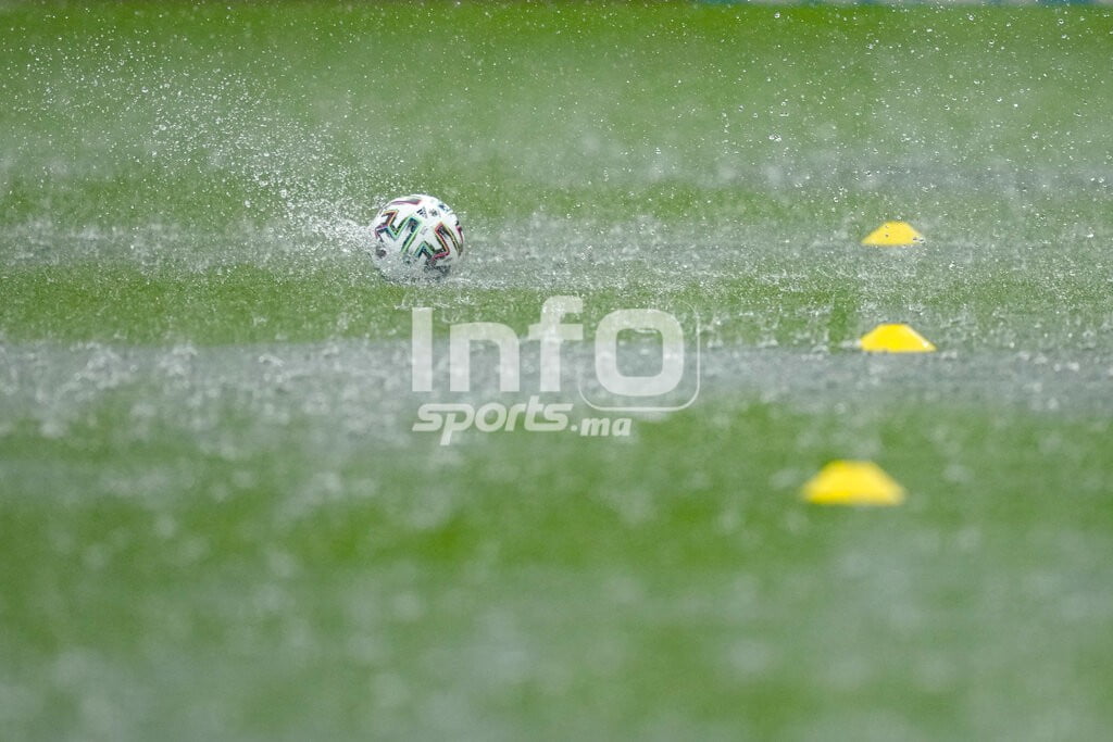 A ball falls on the wet pitch during a heavy rainfall before Austria's training session at the National Arena stadium in Bucharest, Romania, Saturday, June 12, 2021, the day before their first match against North Macedonia. (AP Photo/Vadim Ghirda)