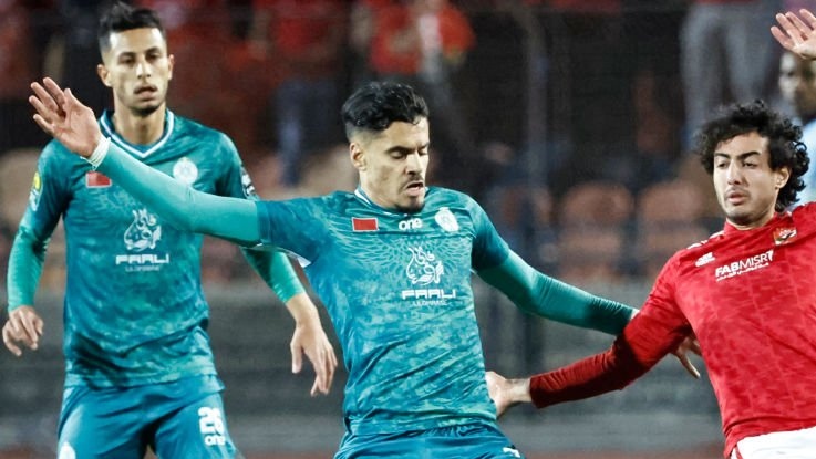 Raja's Moroccan defender Mahmoud Bentayg (C) fights for the ball with Ahly's Egyptian defender Mohamed Hany (R) during the CAF Champions League quarter-final football match between Egypt's Al Ahly and Morocco's Raja Casablanca at Cairo International Stadium in the Egyptian capital on April 22, 2023. (Photo by Khaled DESOUKI / AFP) (Photo by KHALED DESOUKI/AFP via Getty Images)