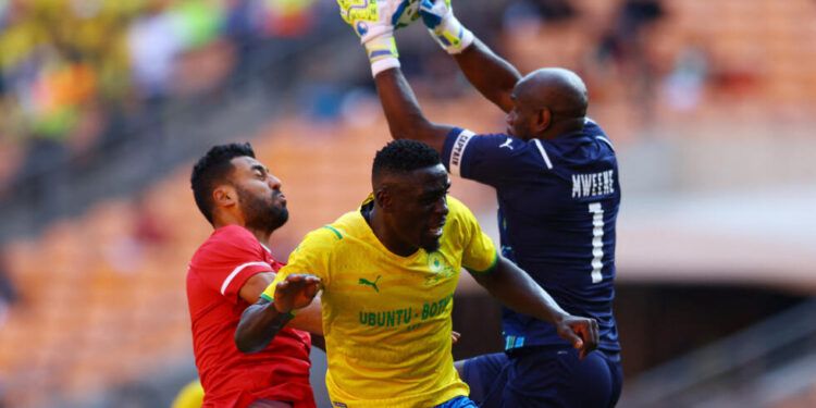 Soccer Football - CAF Champions League - Al-Ahly v Mamelodi Sundowns - FNB Stadium, Johannesburg, South Africa - March 12, 2022 Mamelodi Sundowns' Brian Onyango in action with Al-Ahly's Hossam Hassan REUTERS/Siphiwe Sibeko