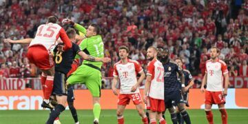 Real Madrid's Ukrainian goalkeeper #13 Andriy Lunin jumps for the ball during the UEFA Champions League semi-final first leg football match between FC Bayern Munich and Real Madrid CF on April 30, 2024 in Munich, southern Germany. (Photo by KERSTIN JOENSSON / AFP)