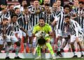 Juventus' Italian goalkeeper Gianluigi Buffon holds the winner's trophy as Juventus players celebrate winning the final of the Italian Cup (Coppa Italia) football match Atalanta vs Juventus on May 19, 2021 at the Citta del Tricolore stadium in Reggio Emilia. (Photo by Miguel MEDINA / AFP)
