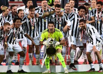 Juventus' Italian goalkeeper Gianluigi Buffon holds the winner's trophy as Juventus players celebrate winning the final of the Italian Cup (Coppa Italia) football match Atalanta vs Juventus on May 19, 2021 at the Citta del Tricolore stadium in Reggio Emilia. (Photo by Miguel MEDINA / AFP)