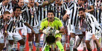 Juventus' Italian goalkeeper Gianluigi Buffon holds the winner's trophy as Juventus players celebrate winning the final of the Italian Cup (Coppa Italia) football match Atalanta vs Juventus on May 19, 2021 at the Citta del Tricolore stadium in Reggio Emilia. (Photo by Miguel MEDINA / AFP)