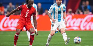 Jun 20, 2024; Atlanta, GA, USA; Argentina forward Lionel Messi (10) plays the ball in front of Canada midfielder Ismael Kone (8) during the first half at Mercedez-Benz Stadium. Mandatory Credit: Dale Zanine-USA TODAY Sports/Sipa USA