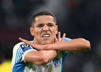 Marseille's French midfielder Amine Harit celebrates scoring his team's third goal during the French L1 football match between Marseille and Nantes at the Velodrome stadium in Marseille on April 20, 2022. (Photo by Christophe SIMON / AFP)