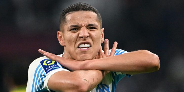 Marseille's French midfielder Amine Harit celebrates scoring his team's third goal during the French L1 football match between Marseille and Nantes at the Velodrome stadium in Marseille on April 20, 2022. (Photo by Christophe SIMON / AFP)